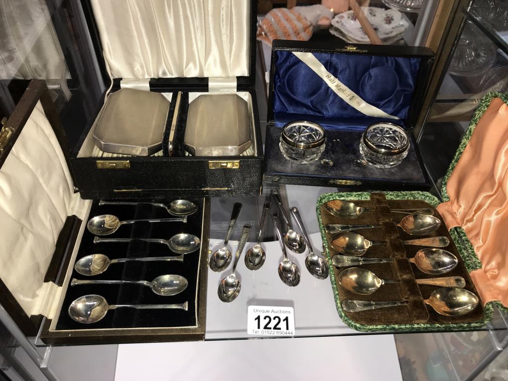 A cased silver rimmed condiment set & spoons, a cased silver backed 2 brush & comb set,