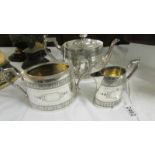 A three piece silver plate tea set.