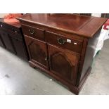 A dark wood stained 2 drawer cupboard with folding top, 96 x 48 x 87 cm high.