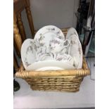 A quantity of Jay Grant fine bone china crockery in wicker basket,