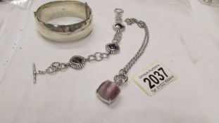 A silver bracelet stamped set with purple stones together with a wide silver vintage bangle and an