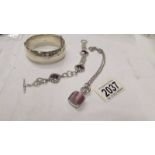 A silver bracelet stamped set with purple stones together with a wide silver vintage bangle and an