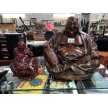 A large hollow resin Buddha & a smaller solid resin Buddha