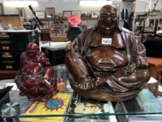 A large hollow resin Buddha & a smaller solid resin Buddha