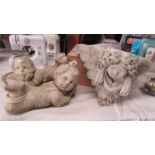 Two cherub garden ornaments and two others.