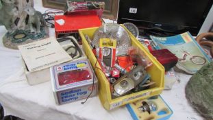 A mixed lot of motoring items including speedometer, lights, battery charger etc.