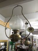 A hanging oil lamp complete with burner and shade.