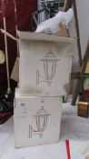 A pair of new boxed porch lights.