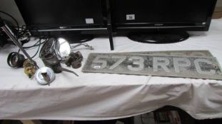 A pair of old car number plates, wing mirrors, oil can etc.