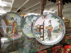 Three signed oriental collectors plates.