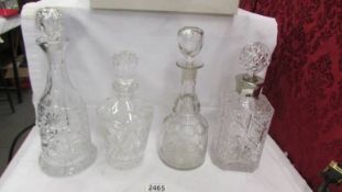 Four cut glass decanters, various designs.