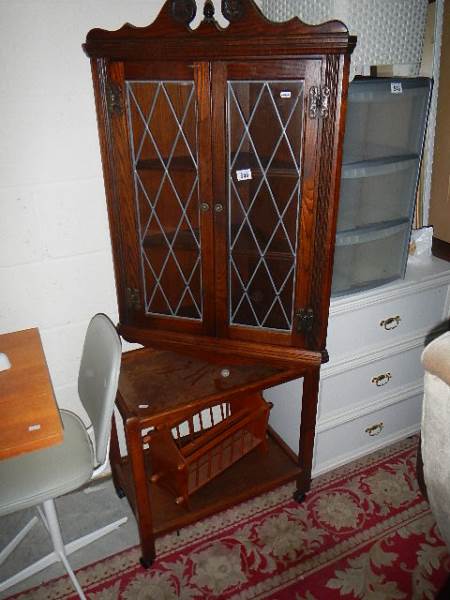 A lead glazed corner cabinet, an oak trolley and a magazine rack. (Collect only).