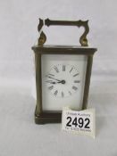 A brass carriage clock.