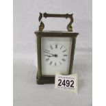 A brass carriage clock.