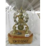 A good brass skeleton clock under glass dome.