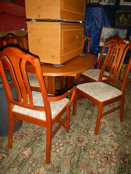 A good quality teak style dining table and five chairs. (Collect only).