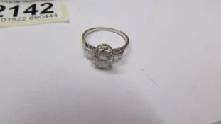 An 18ct gold diamond ring of approximately 1.9 grams with brilliant cut diamond shoulders, size O.