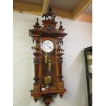 A Victorian twin weight mahogany Vienna wall clock, the case surmounted with horses,