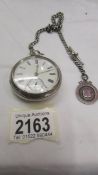 A silver pocket watch on silver Albert with silver fob, (chain 35 grams). In working order.