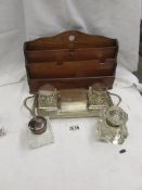 A silver plate desk stand with 2 glass inkwells, 2 other glass inkwells and an oak letter rack.