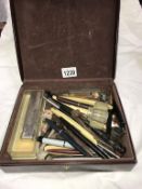 A small case full of old interesting penknives, pipes, razors, mouth organ & fountain pens etc.