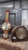 A mantel clock and a banjo barometer.
