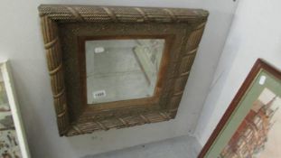 An unusual square framed bevel edged mirror