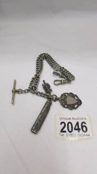A silver watch fob, a silver pen knife, a white metal imp all on a white metal watch chain.