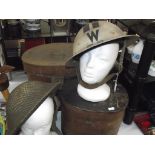 A WWII helmet and a WWII air warden helmet,