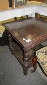 A 19th century carved oak occasional table.