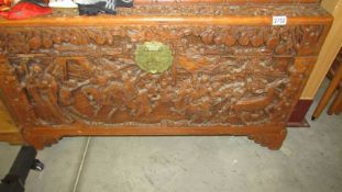 A large carved camphor wood box.