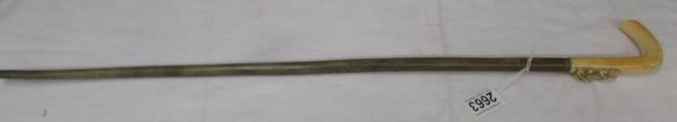 A 19th century walking stick with carved handle.