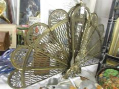 A brass folding fan shaped fire screen.