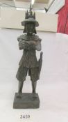 A 19/20th century carved wooden Japanese Samurai figure (chip to side of hat otherwise in good