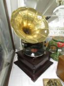 A horn gramaphone with decorative brass horn.