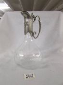 A good quality glass claret jug with plated spout marked 'Les Elains du Boucrgue'.