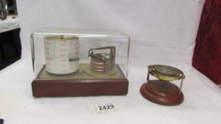 A small barograph and a brass compass.