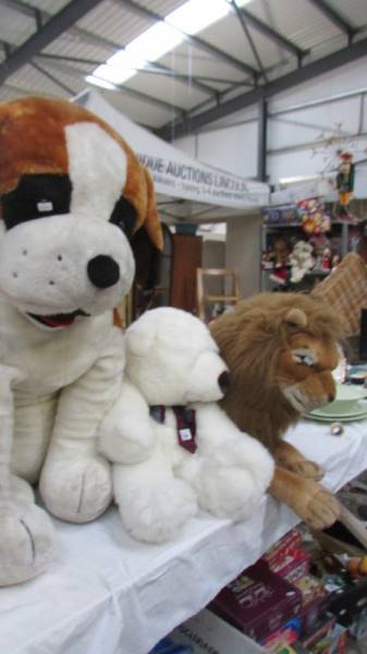 A large St. Bernard, a lion and a white bear.