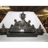 A heavy bronze and slate clock/desk stand with 2 inkwells, (one hinge a/f) in working order.