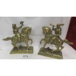 A pair of heavy brass horses with riders.