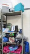 Four shelves of camping equipment including tents, cool boxes etc.