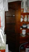 A oak corner cabinet with glass top and shelves. (Collect only).