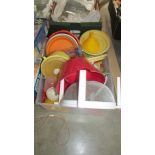 A box of plastic kitchen ware.