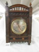 A Winterhald & Hoffmeier mantle clock in oak case.