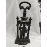 A heavy old cast iron knight door stop.