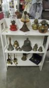 A mixed lot of brass ware etc., including oil lamp fonts, bells, measures etc.