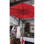 A large garden parasol in good condition.