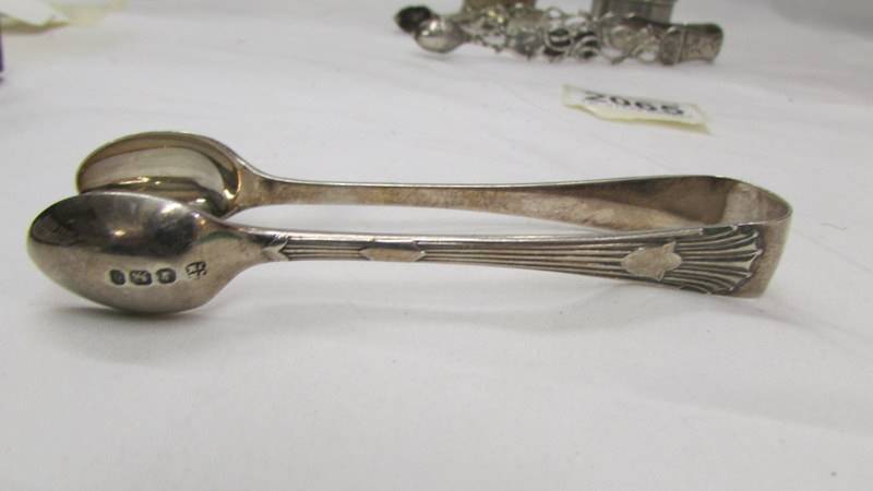 Two hall marked silver sugar tongs and two silver napkin rings. - Image 2 of 4