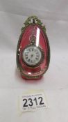 A superb cranberry glass pocket watch case with Victorian silver fob watch.