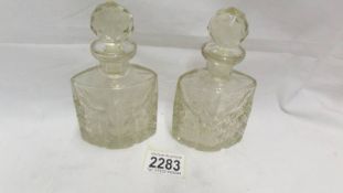 A pair of cut glass scent bottles.